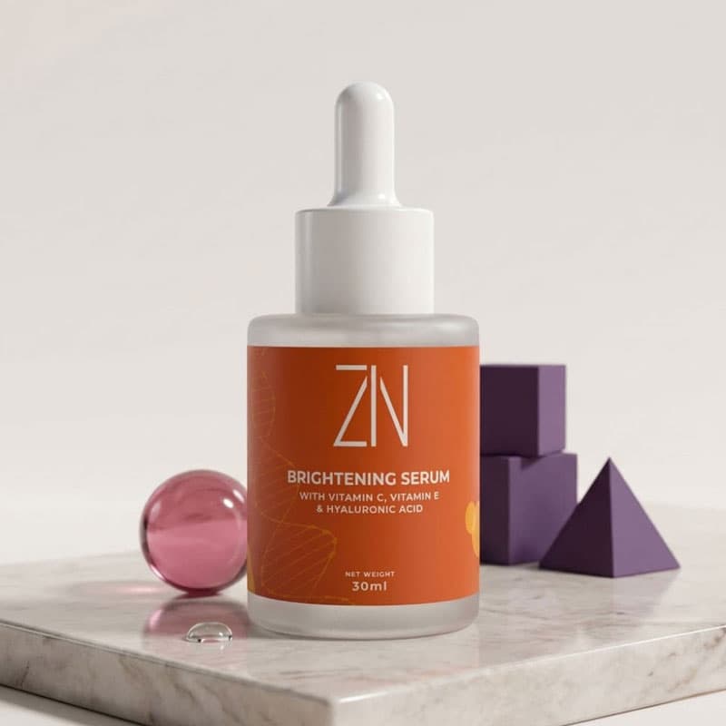 ZIN brightening serum bottle on a marble surface with geometric purple objects in the background
