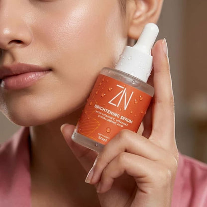 Person holding a skincare serum bottle with a blurred background